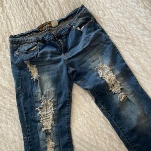 V.I.P. Cropped, distressed jeans with patches